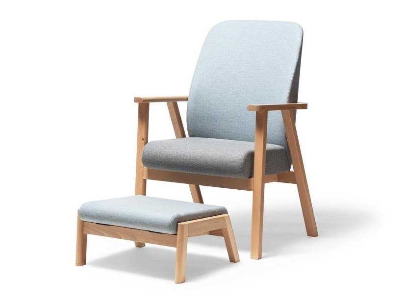 Upholstered fabric armchair with footstool